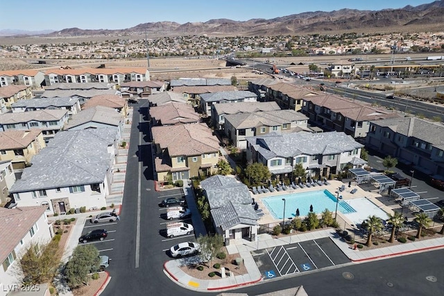 birds eye view of property with a mountain view and a residential view