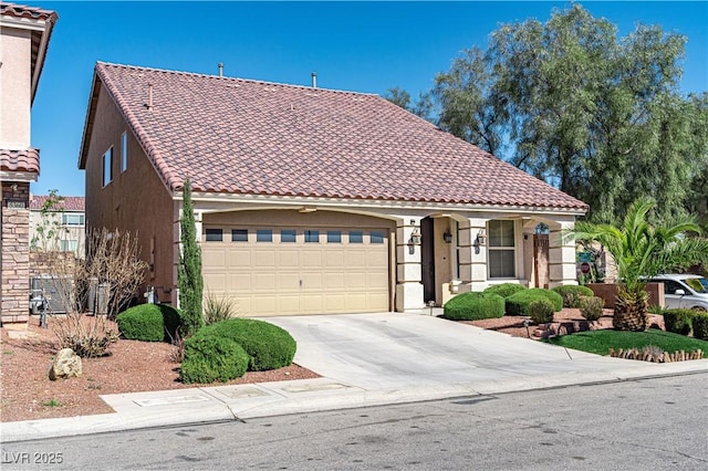 mediterranean / spanish house with driveway, a tiled roof, a garage, and stucco siding