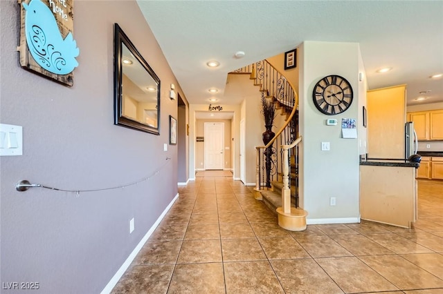 corridor featuring stairs, light tile patterned floors, recessed lighting, and baseboards