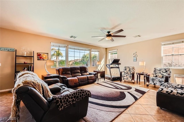 living room with light tile patterned floors, visible vents, baseboards, and ceiling fan