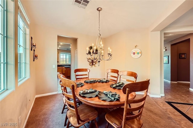 dining area with visible vents, baseboards, and a chandelier