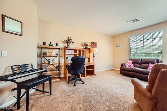 office space featuring visible vents, baseboards, and light carpet