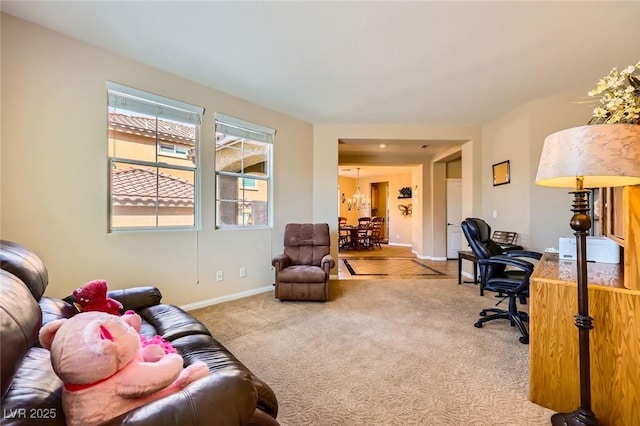 office featuring carpet flooring, baseboards, and a chandelier