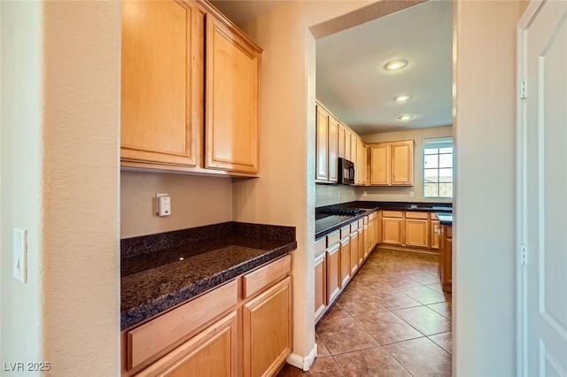 kitchen featuring black microwave, light brown cabinetry, recessed lighting, dark stone countertops, and tile patterned floors