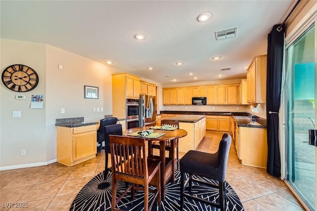 kitchen featuring light brown cabinets, recessed lighting, appliances with stainless steel finishes, light tile patterned flooring, and a sink