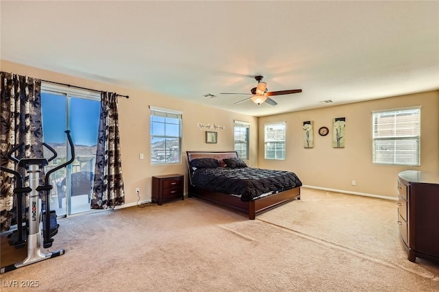 bedroom with baseboards, multiple windows, and light colored carpet