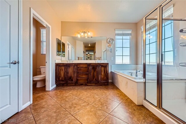 bathroom featuring toilet, a stall shower, a bath, tile patterned floors, and a sink