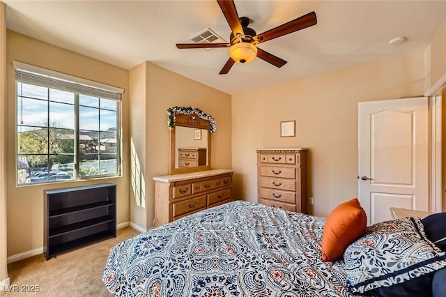 bedroom featuring a ceiling fan, light colored carpet, visible vents, and baseboards