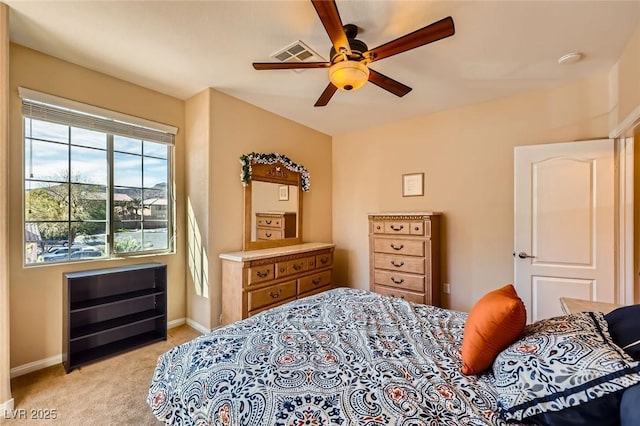 bedroom featuring visible vents, light carpet, baseboards, and ceiling fan
