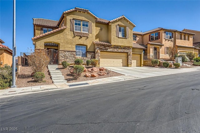 mediterranean / spanish-style home with stucco siding, a tile roof, stone siding, concrete driveway, and a garage