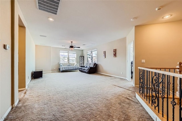 interior space with carpet flooring, baseboards, visible vents, and ceiling fan