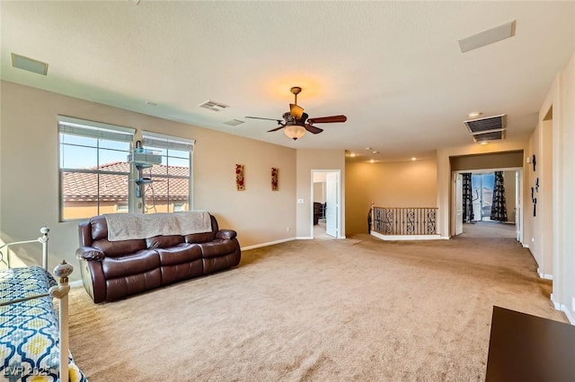 living room featuring visible vents, baseboards, carpet, and a ceiling fan