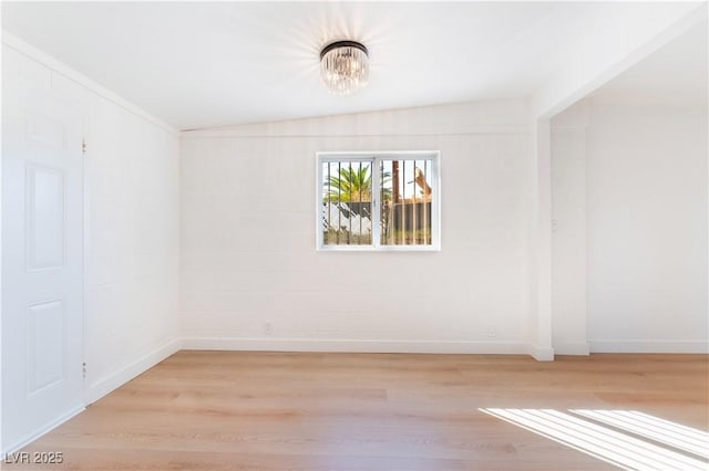 spare room with light wood-type flooring and baseboards