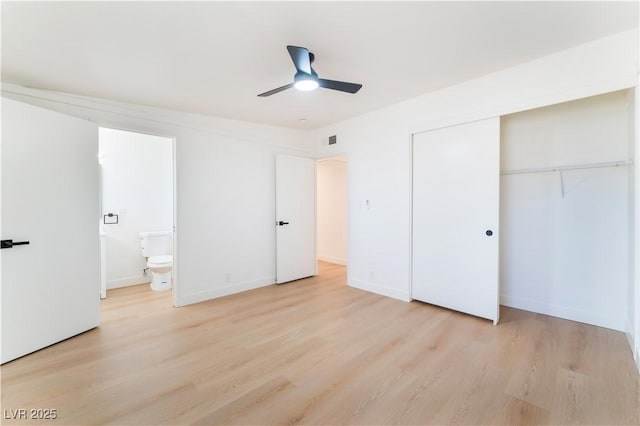 unfurnished bedroom featuring light wood finished floors, baseboards, visible vents, ensuite bathroom, and a closet