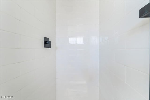 bathroom with tiled shower