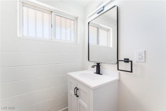 bathroom with vanity and concrete block wall