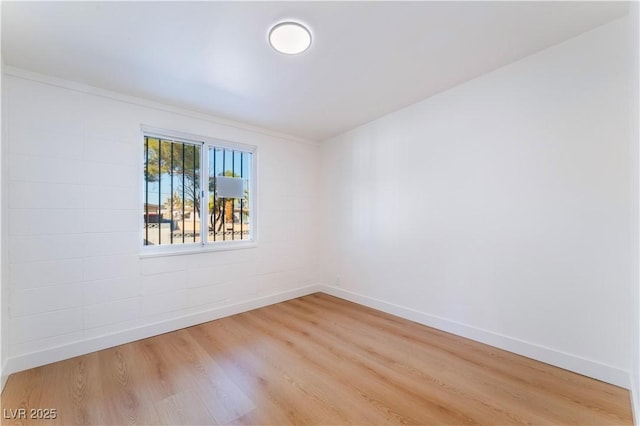 unfurnished room with light wood finished floors and baseboards