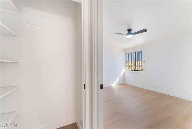 interior space with ceiling fan and wood finished floors