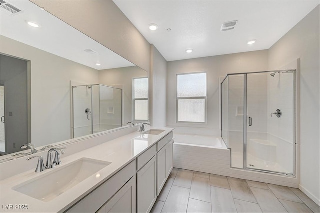 full bath featuring a garden tub, a stall shower, a sink, and visible vents