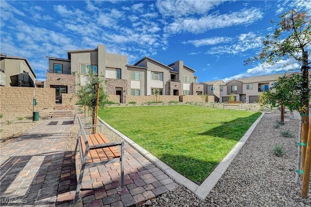 surrounding community with a lawn, fence, and a residential view