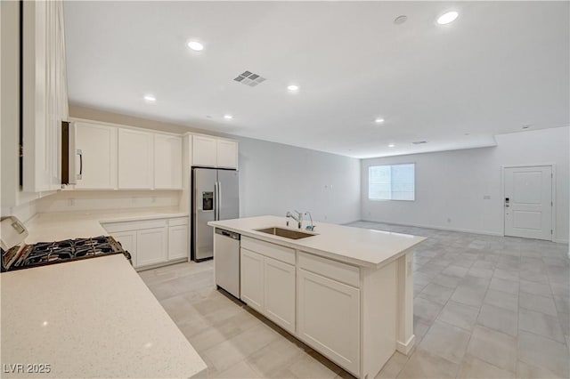 kitchen featuring a sink, visible vents, range with gas stovetop, stainless steel fridge with ice dispenser, and dishwasher