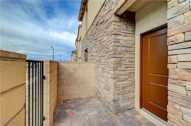 doorway to property with stone siding