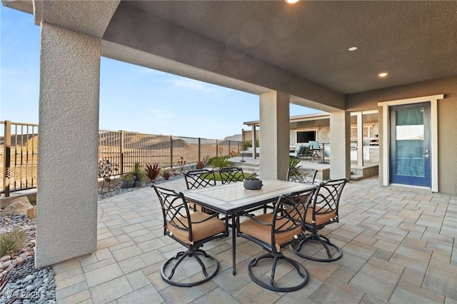 view of patio / terrace featuring outdoor dining area and fence