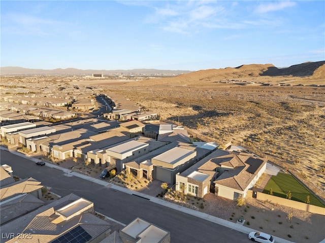 aerial view featuring view of desert, a residential view, and a mountain view