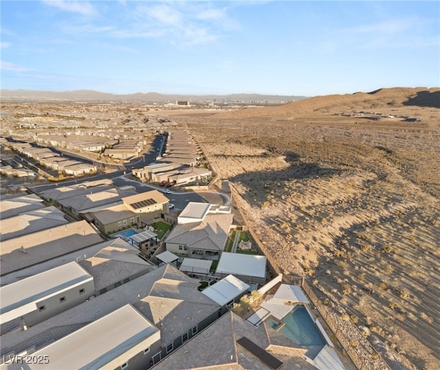 aerial view featuring a residential view, a desert view, and a mountain view