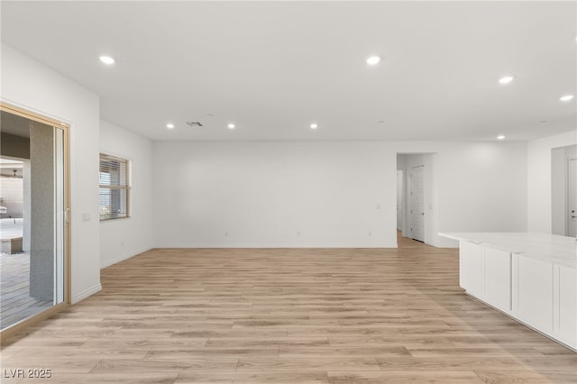 unfurnished room with recessed lighting, baseboards, visible vents, and light wood finished floors