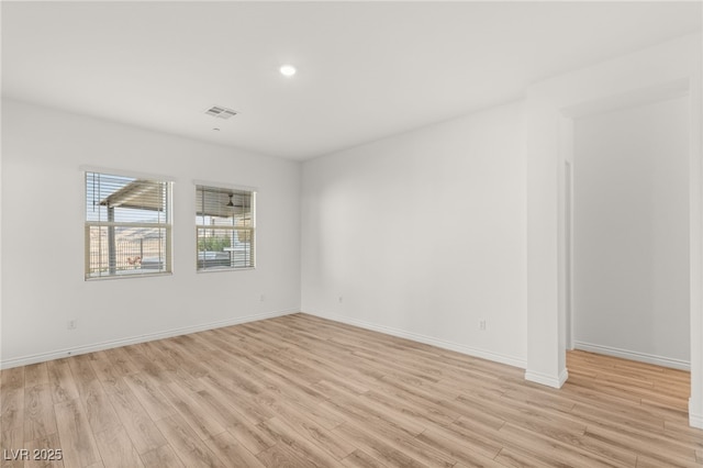 spare room with recessed lighting, visible vents, light wood-style flooring, and baseboards