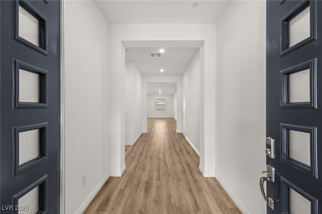 foyer entrance featuring recessed lighting, visible vents, light wood-style flooring, and baseboards