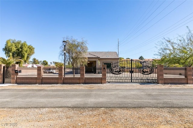 view of front of house with a fenced front yard and a gate