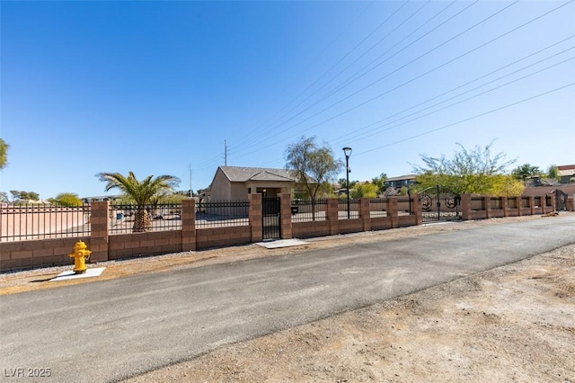 exterior space with street lighting and a gate