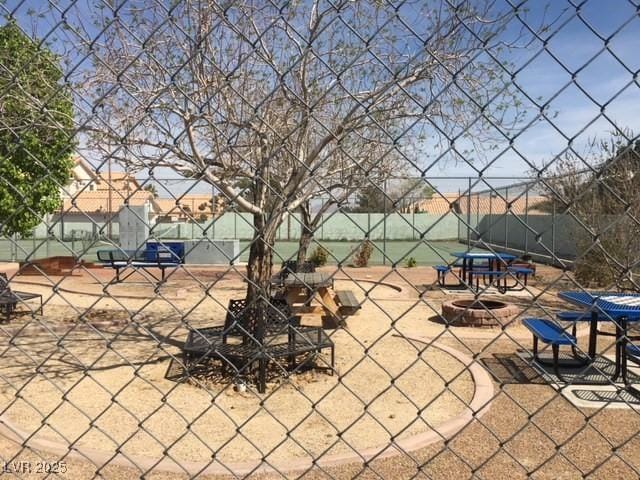 surrounding community featuring a fire pit, a patio area, and fence