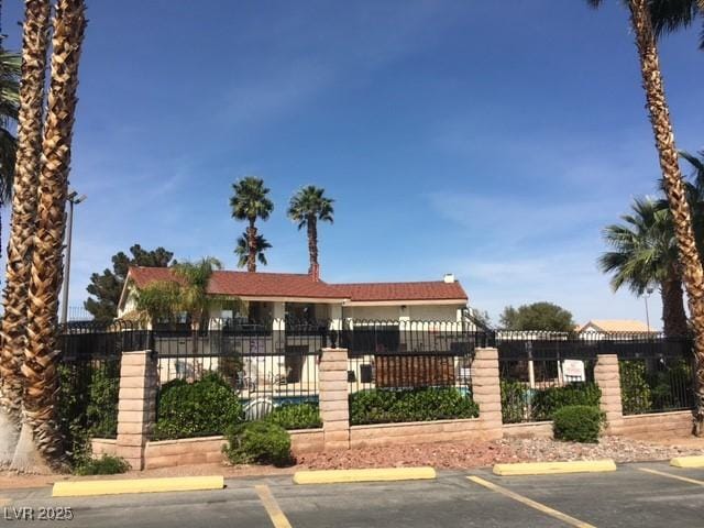 exterior space with uncovered parking and fence