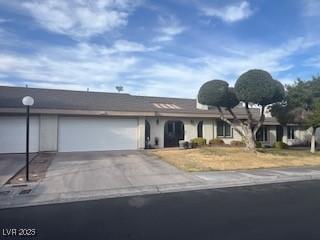 single story home with a garage and driveway