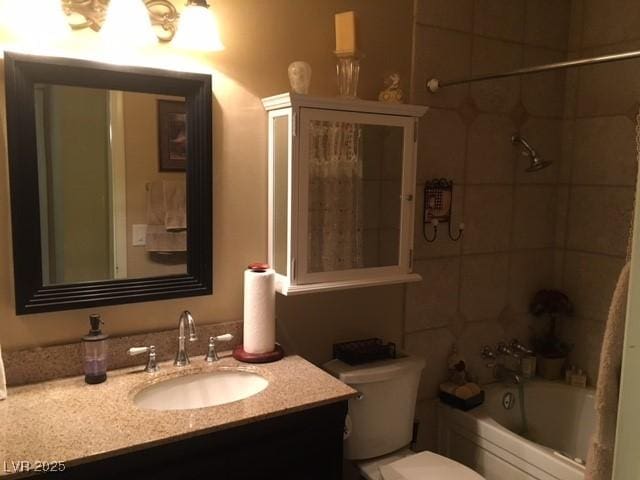 full bath featuring shower / bathtub combination, toilet, and vanity