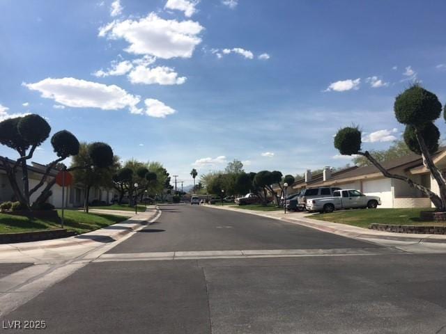 view of road with curbs, traffic signs, and sidewalks