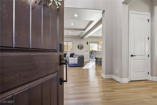 entrance foyer featuring light wood-style floors, baseboards, and recessed lighting