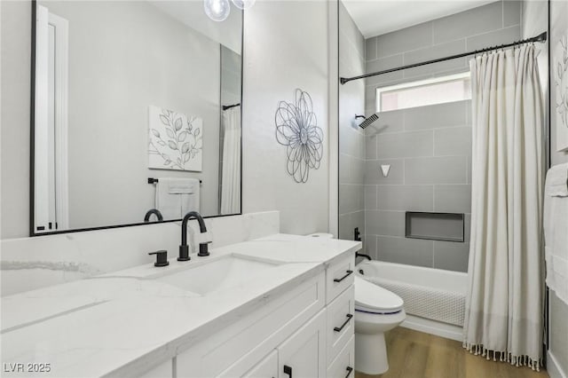 full bathroom featuring vanity, shower / tub combo, wood finished floors, and toilet