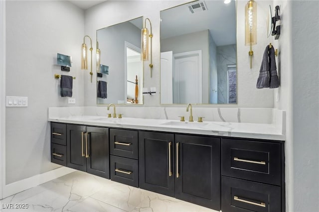 full bath with marble finish floor, visible vents, a sink, and double vanity