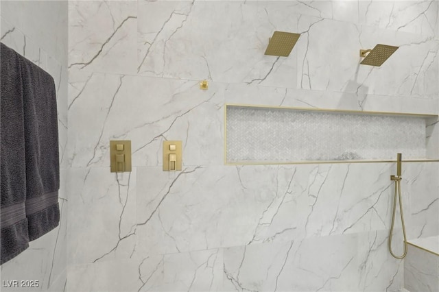 interior details featuring a marble finish shower