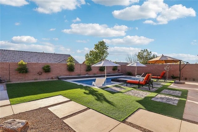 view of swimming pool featuring a fenced backyard, a lawn, and a patio