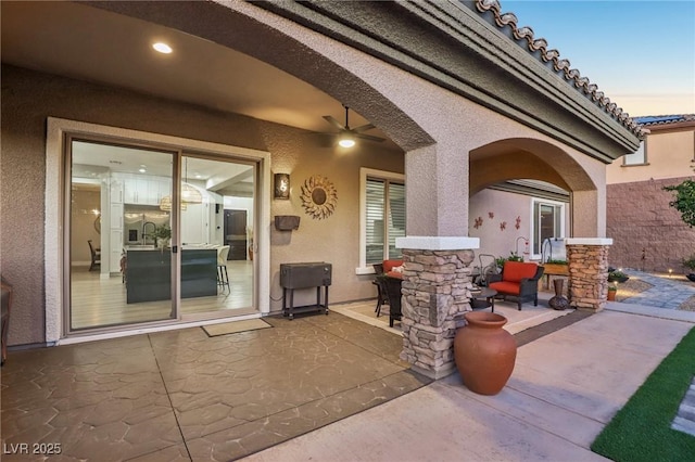 view of patio / terrace featuring a sink and a ceiling fan