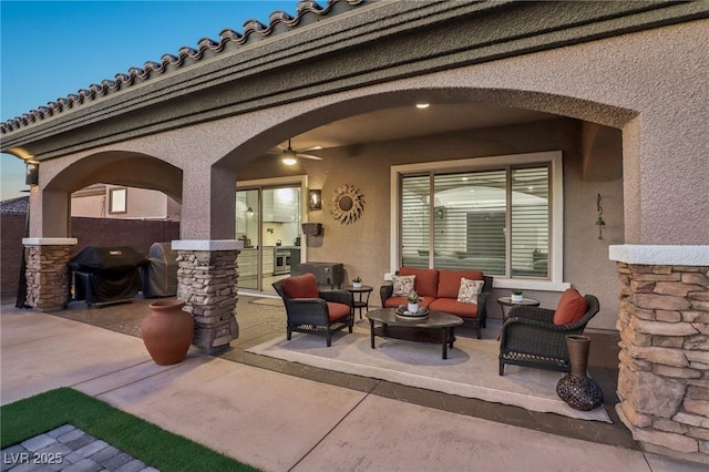 view of patio featuring ceiling fan, an outdoor living space, and area for grilling