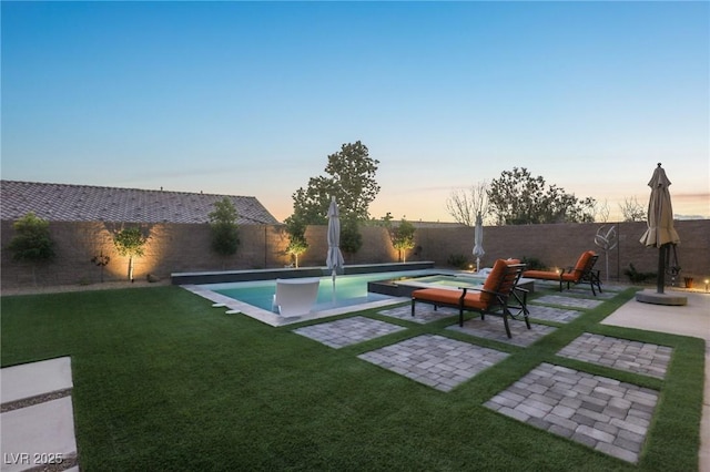 exterior space featuring a fenced backyard, a fenced in pool, a lawn, and a patio