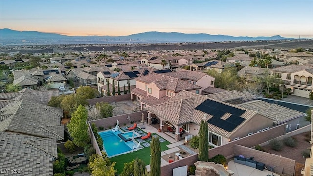 aerial view at dusk with a mountain view and a residential view