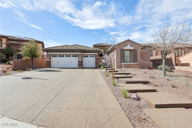 view of front of house with a garage, concrete driveway, a tiled roof, and stucco siding