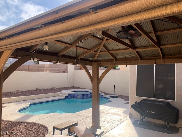 view of swimming pool featuring area for grilling, a pool with connected hot tub, a patio, a fenced backyard, and a gazebo